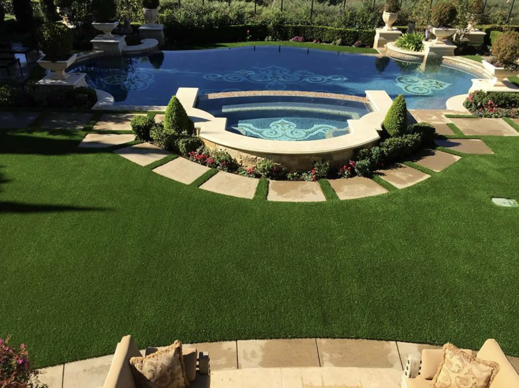 Anastasia Island full transformation: putting green, travertine patio and fire pit under live oaks