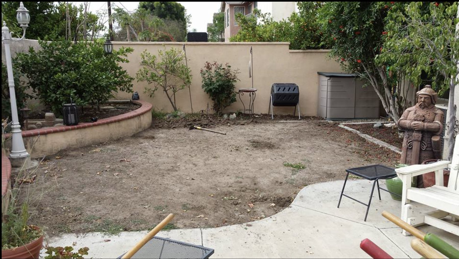 Backyard before: bare dirt and patchy ground